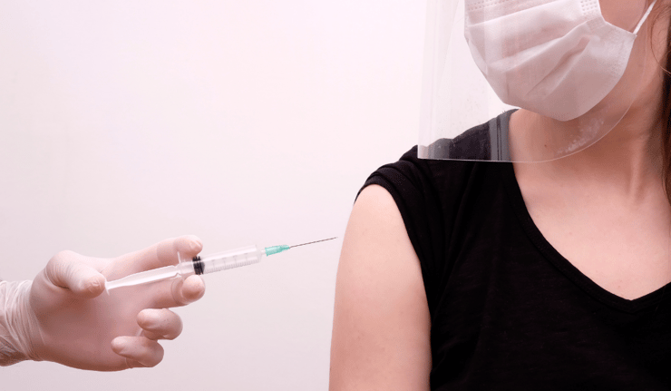 Person getting a vaccination shot in the arm